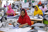 Bangladeshi garment workers sew at a textile factory in Gazipur