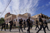Syrian security forces deployed in the village of Al-Soura al-Kubra