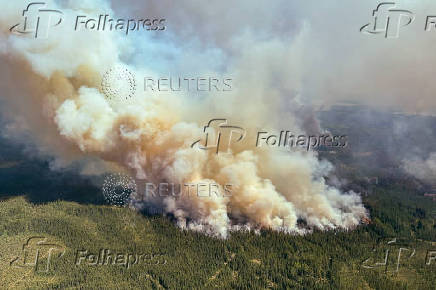 FILE PHOTO: Smoke rises from wildfire LWF090, the Caribou Lake Wildfire in Alberta