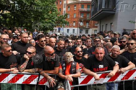 AC Milan 'ultra' soccer fans wait outside a high-security courtroom in Milan, Italy