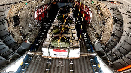Humanitarian aid packages for Gaza sit inside an aircraft at a military airport in Cairo
