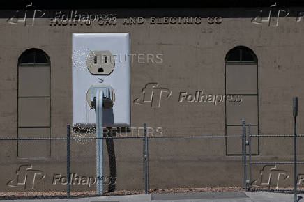 A giant electrical outlet is displayed at a PG&E substation building in Petaluma, California