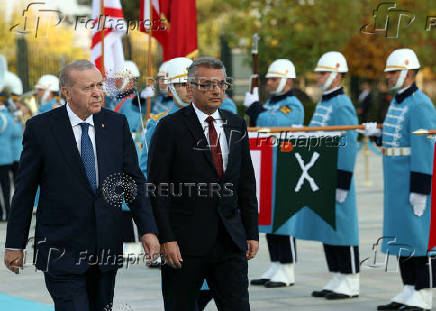 Turkey's President Tayyip Erdogan and Turkish Cypriot leader Tufan Erhurman attend a welcoming ceremony at the Presidential Palace in Ankara