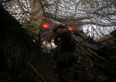 Servicemen fire a howitzer towards Russian troops at a position in a front line in Donetsk region