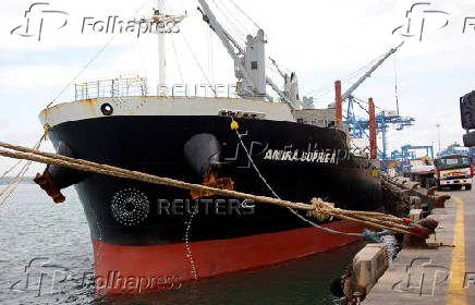 Workers unload a shipment of rice from the MV Amira Sophie II, at the Kenya Ports Authority (KPA) container terminal in the port of Mombasa