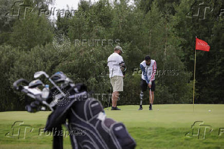 Ukrainian war veterans take part in a golf tournament outside of Kyiv