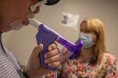 Retired coal miner performs spirometry test in Vansant, Virginia
