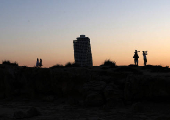 People walk during sunset on Makronissos beach in the resort of Ayia Napa