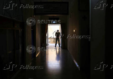 A UN soldier stands at the entrance of Ledra Palace during a photography exhibition of the Bi-communal Committee for Missing Persons in Cyprus