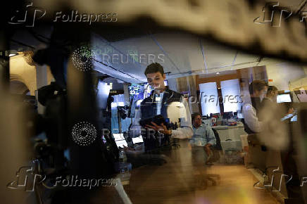 Traders work on the floor at the New York Stock Exchange (NYSE) in New York City