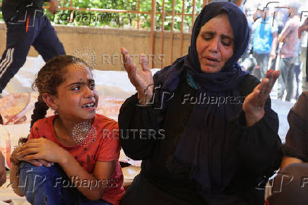 Palestinians mourn loved ones killed in Israeli fire while seeking aid, at Nasser Hospital in Khan Younis, southern Gaza Strip