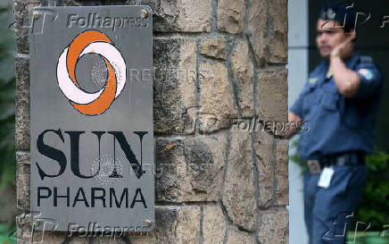 FILE PHOTO: A guard walks inside the office of Sun Pharmaceutical Industries Ltd in Mumbai