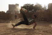 Yemeni youths play soccer in Sana'a