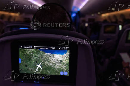 A screen shows a commercial flight landing at Chicago International Airport O'Hare, as the government shutdown continues