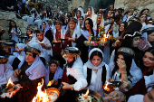 Iraqi Yazidis attend a ceremony on the occasion of Red Wednesday, to celebrate the Yazidi New Year, at Lalish temple in Shekhan District near Duhok province