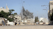A girl runs from the scene after Israeli strikes on a school sheltering displaced people at the Bureij refugee camp in the central Gaza Strip