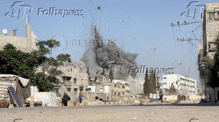 A girl runs from the scene after Israeli strikes on a school sheltering displaced people at the Bureij refugee camp in the central Gaza Strip