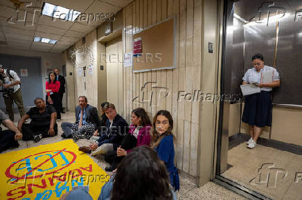 New York state lawmakers and New York City Comptroller Brad Lander conduct a sit in demonstration after being denied access to inspect the conditions of detention cells at U.S. immigration court in New York City