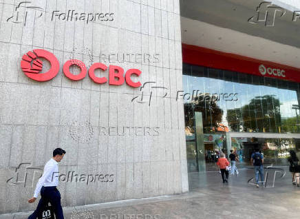 People walk in front of the Oversea-Chinese Banking Corp (OCBC) headquarters in Singapore