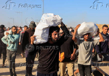 Palestinians receive aid from the U.S.-backed Gaza Humanitarian Foundation, in Khan Younis
