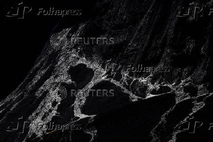 Debris and dust from a crumbling glacier that partially collapsed and tumbled onto the village of Blatten