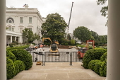 Workers reconstruct the Rose Garden to pavement at the White House