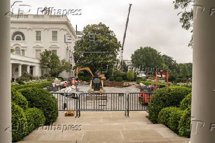 Workers reconstruct the Rose Garden to pavement at the White House