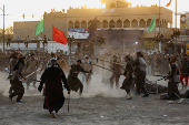 Volunteers re-enact a scene from the 7th-century Battle of Karbala to commemorate Ashura in Baghdad