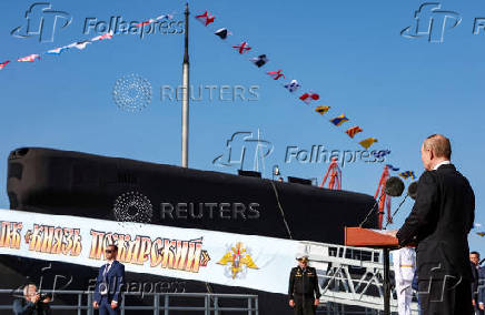Russian President Vladimir Putin attends a ceremony of raising a naval flag aboard the Knyaz Pozharsky nuclear-powered ballistic missile submarine in Severodvinsk