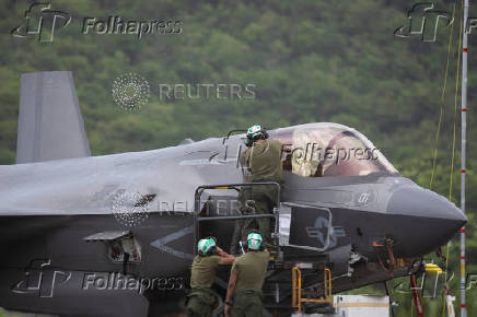 U.S. Marine Corps ground crew service an F-35 fighter jet after it landed at the former Roosevelt Roads military base in Ceiba