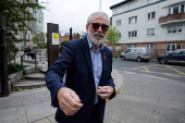 Former Sinn Fein President Gerry Adams walks outside the High Court, in Dublin