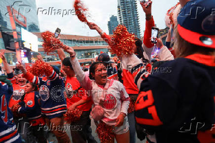 Edmonton Oilers fans react in a fan zone during the first game of the Stanley Cup Finals against the Florida Panthers, in Edmonton
