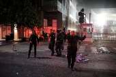 Security personnel react at an impact site following a missile attack from Iran on Israel, at Tel Aviv