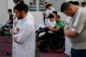 Palestinians from Gaza attend Eid al-Adha prayers, at Al Thumama Complex,  in Doha