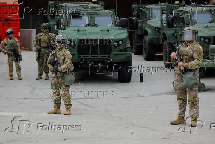 California National Guard troops stand outside the Edward R. Roybal federal building, in Los Angeles