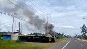 Smoke rises from a structure, amid the clashes between Thailand and Cambodia, in Kantharalak district