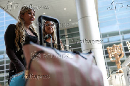 Israeli nationals arrive at Ben Gurion International airport from abroad, in Tel Aviv