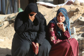 Mourners react during the funeral of Palestinians killed in overnight Israeli strikes, according to medics, at Al-Shifa hospital in Gaza City