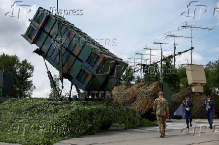 FILE PHOTO: Ukrainian service members walk next to a launcher of a Patriot air defence system an undisclosed location in Ukraine