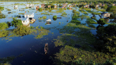 Families live surrounded by water due to heavy rains causing flooding in central Bolivia, in Trinidad