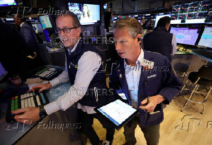 Traders work on the floor at the New York Stock Exchange, in New York City