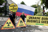Activists of Greenpeace attend a protest near the Russian Embassy in Paris