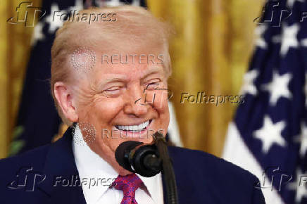 U.S. President Trump signs a resolution at the White House