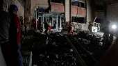 Members of the Iranian Red Crescent Society work at a site of a strike