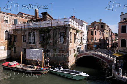 Beginning of the restoration process of Banksy's 'Migrant Child', in Venice