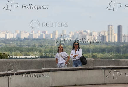People look at Ukrainian capital Kyiv