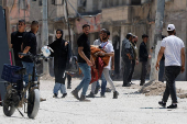 Palestinians carry their belongings after Israel's decision to demolish their homes in Nur Shams camp