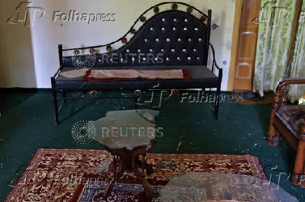 A broken coffee table is pictured inside a residential house that was partially damaged beside Bilal Mosque after it was hit by an Indian strike in Muzaffarabad