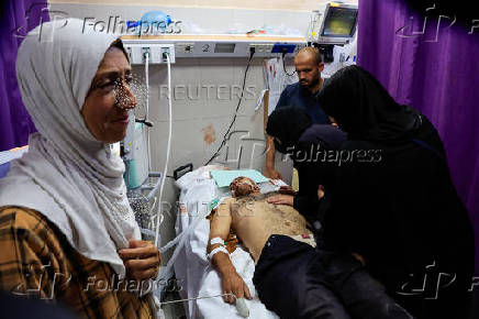 A Palestinian, wounded in an Israeli strike, receives treatment, in Khan Younis