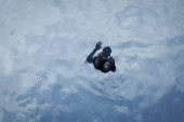 People swim in the Sky Pool during hot weather in London